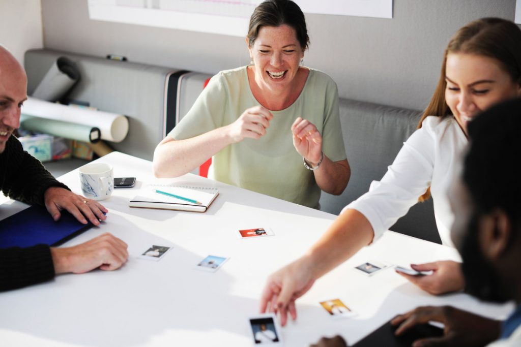Team members playing a card game in an office space